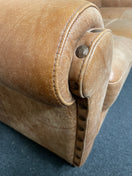 A three-seater tan leather sofa with broad, cushioned armrests W180x94D  44493