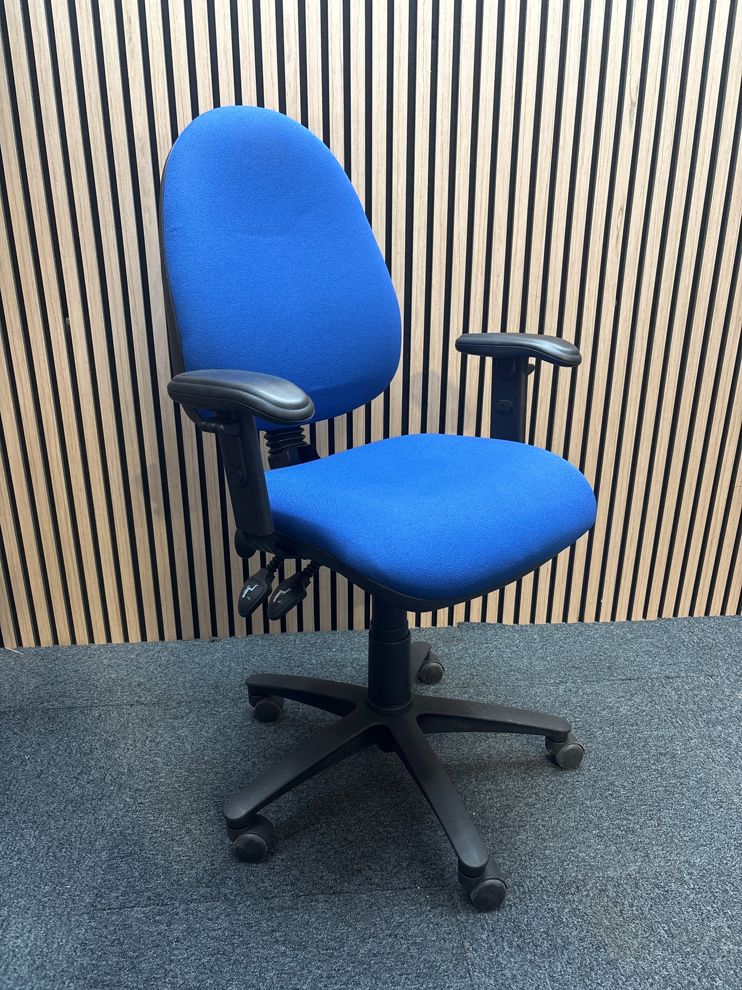 Jota medium back swivel chair in dark blue fabric with pump up lumbar support and height adjustable arms.