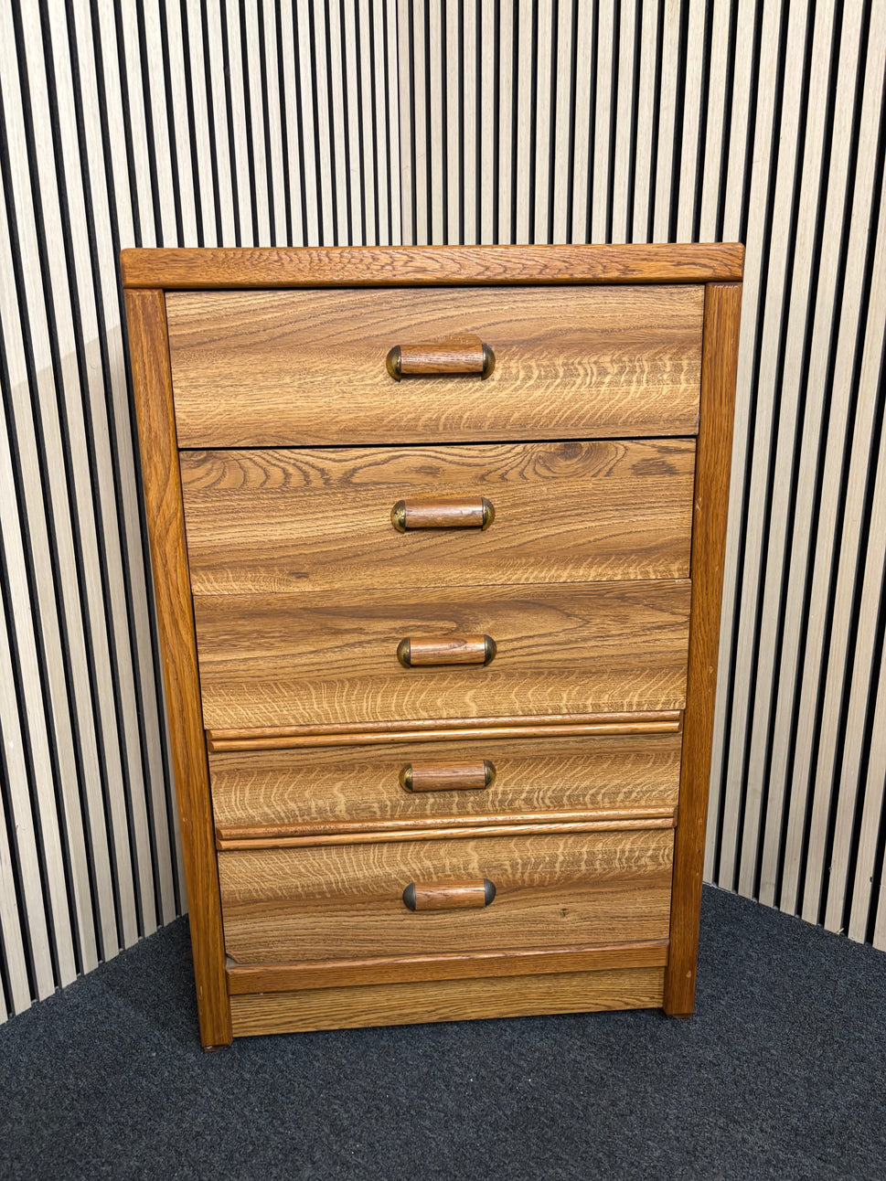 Tall wooden chest with five drawers and rounded handles