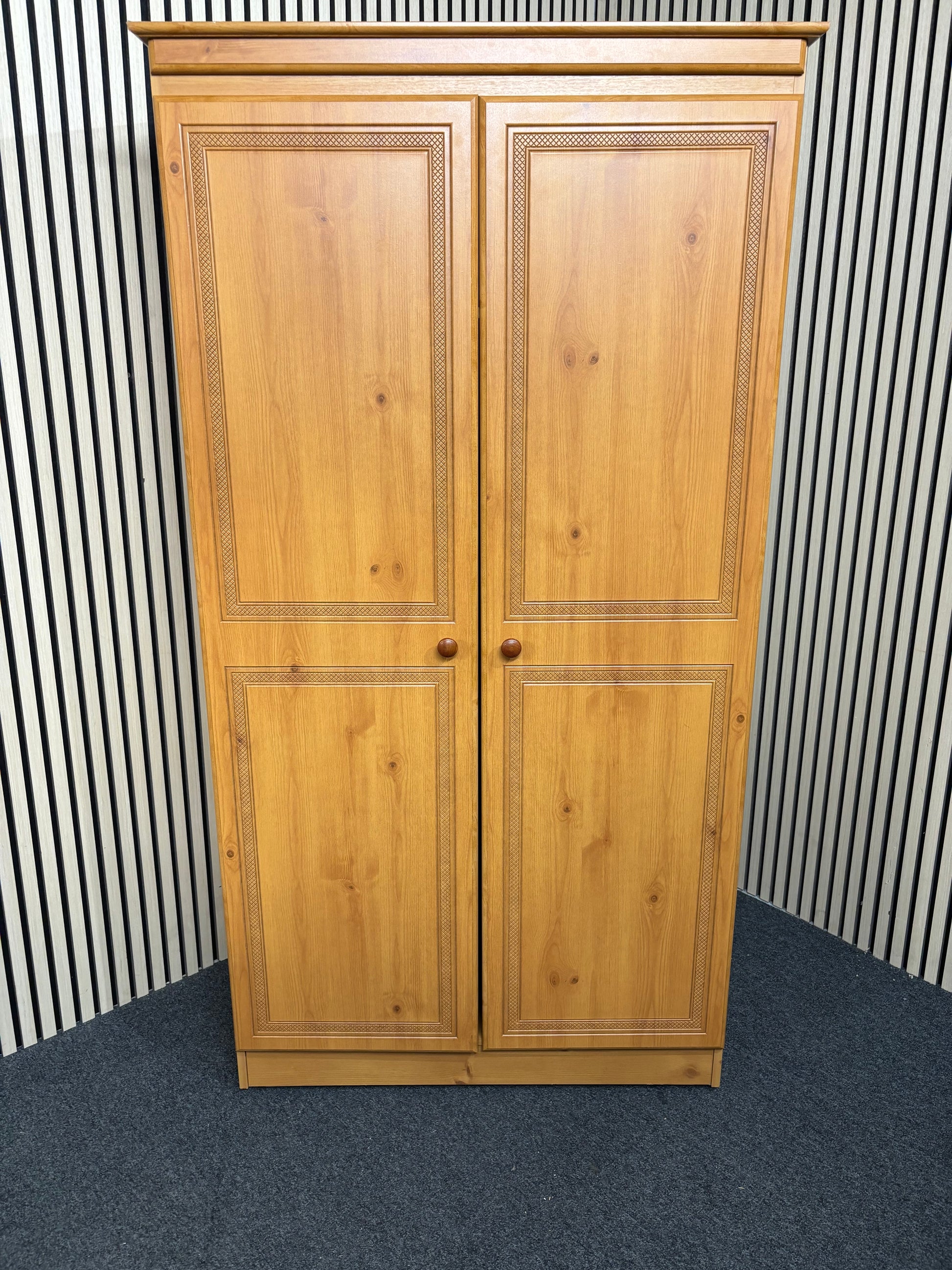 Solid pine wooden wardrobe with two paneled doors and round knobs