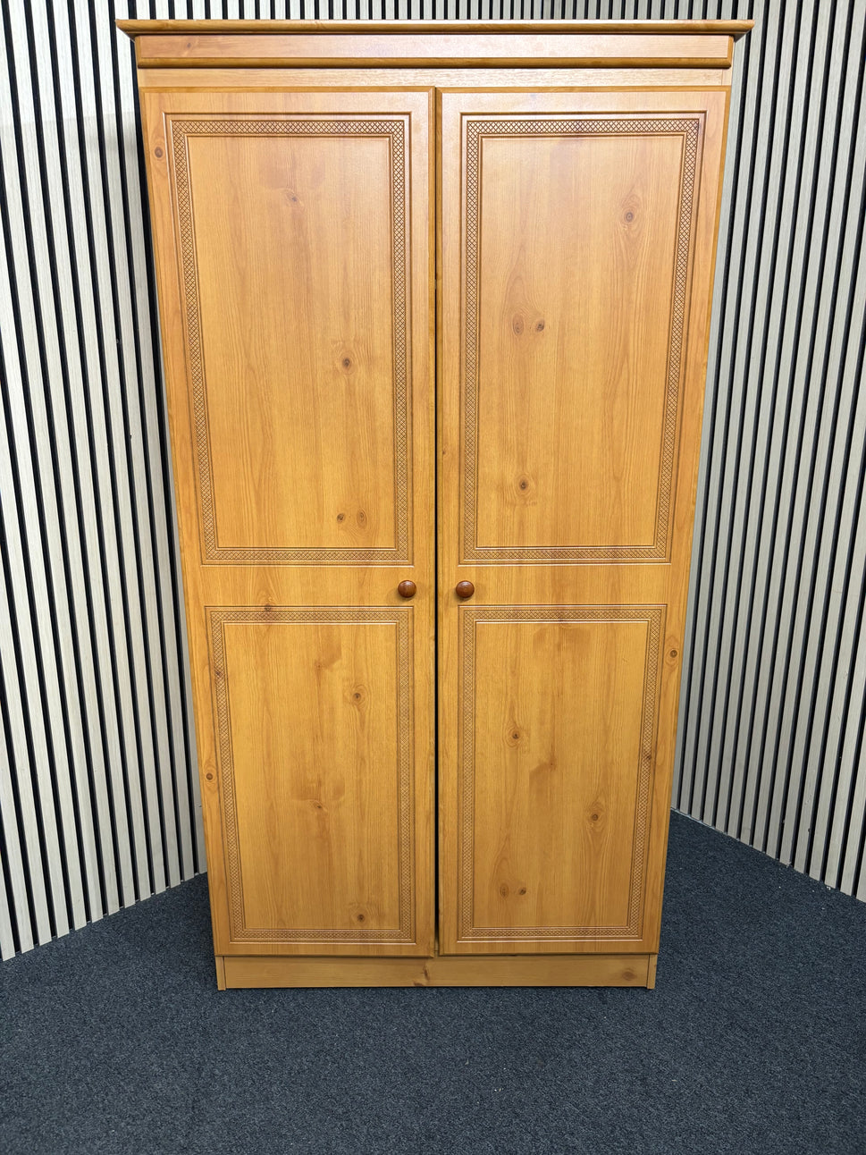 Solid pine wooden wardrobe with two paneled doors and round knobs