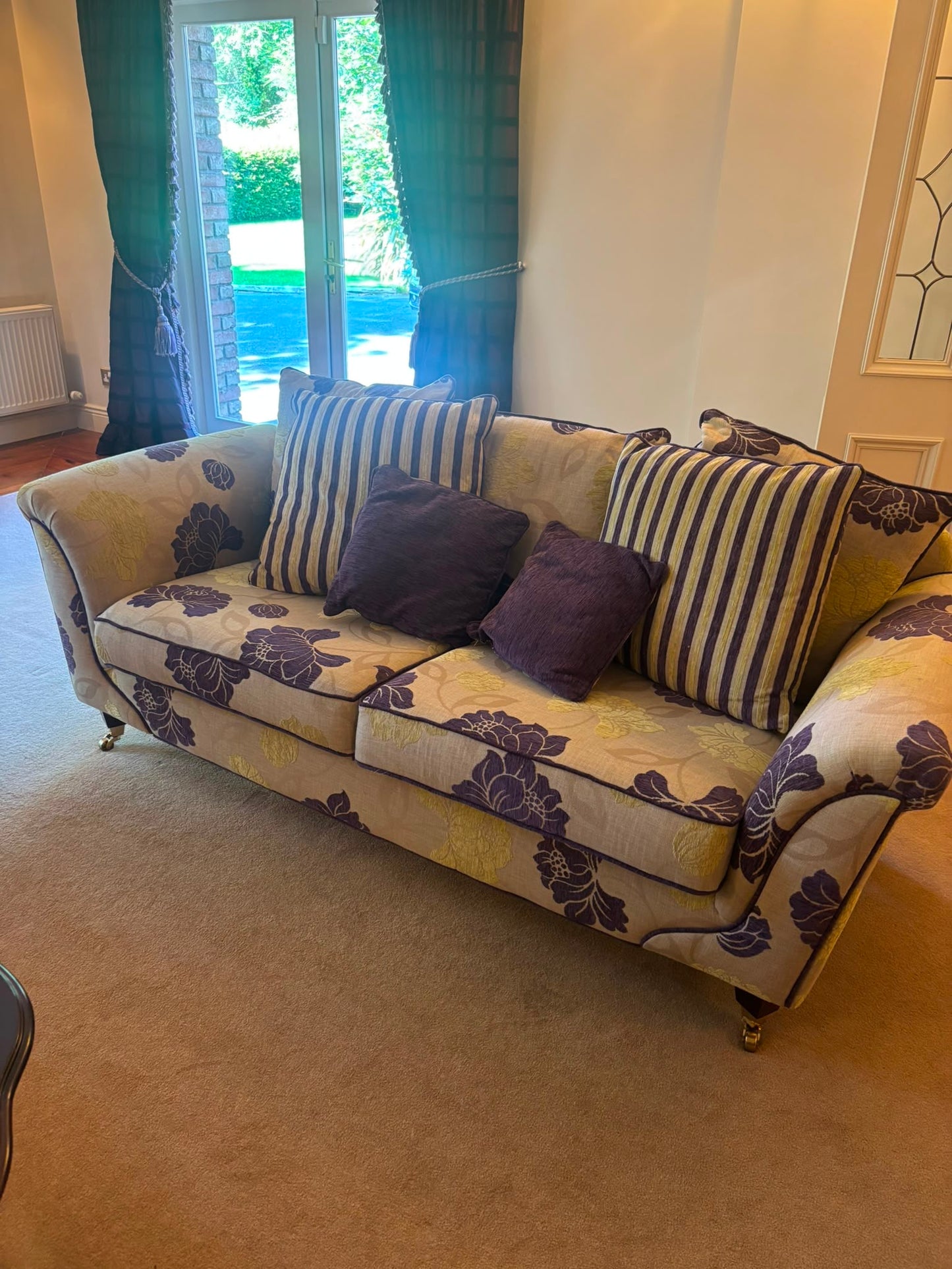 Floral patterned three seat sofa with brass castors  43783
