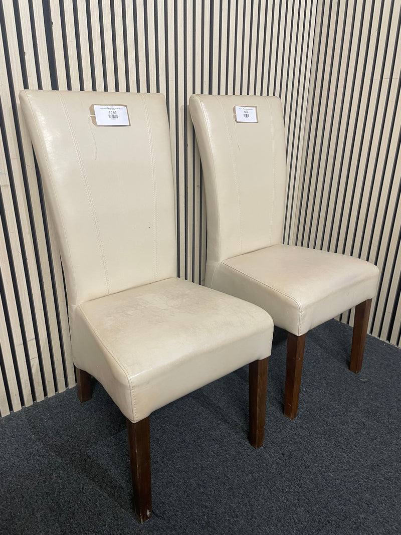 Pair of cream faux leather dining chair with dark wood legs.  44698