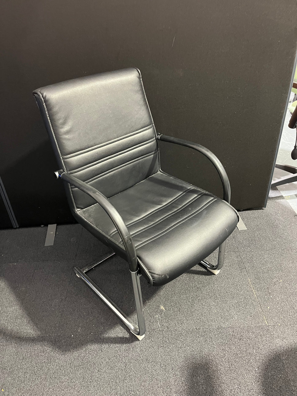 Black leather cantilever meeting chair with chrome frame