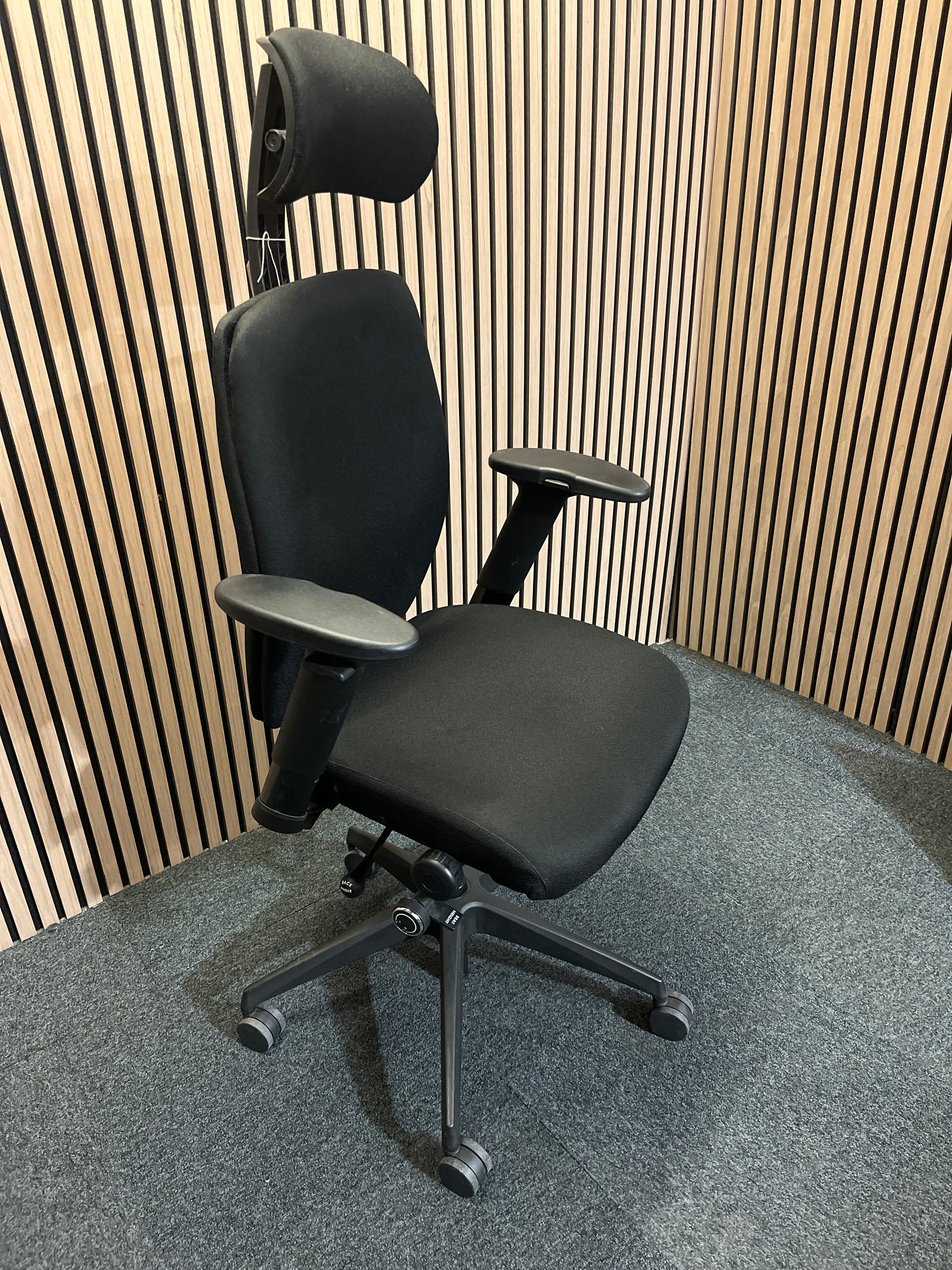 Black fabric fully ortho swivel chair with adjustable arms and high back in black fabric