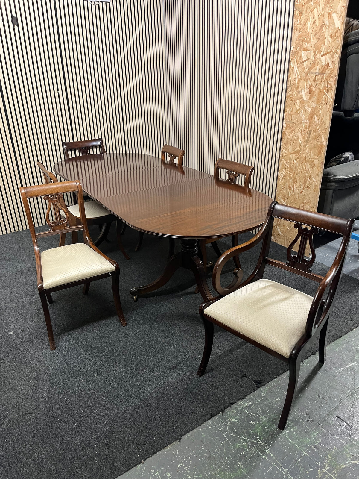 Mahogany dining set including oval pedestal table and six chairs.  44369