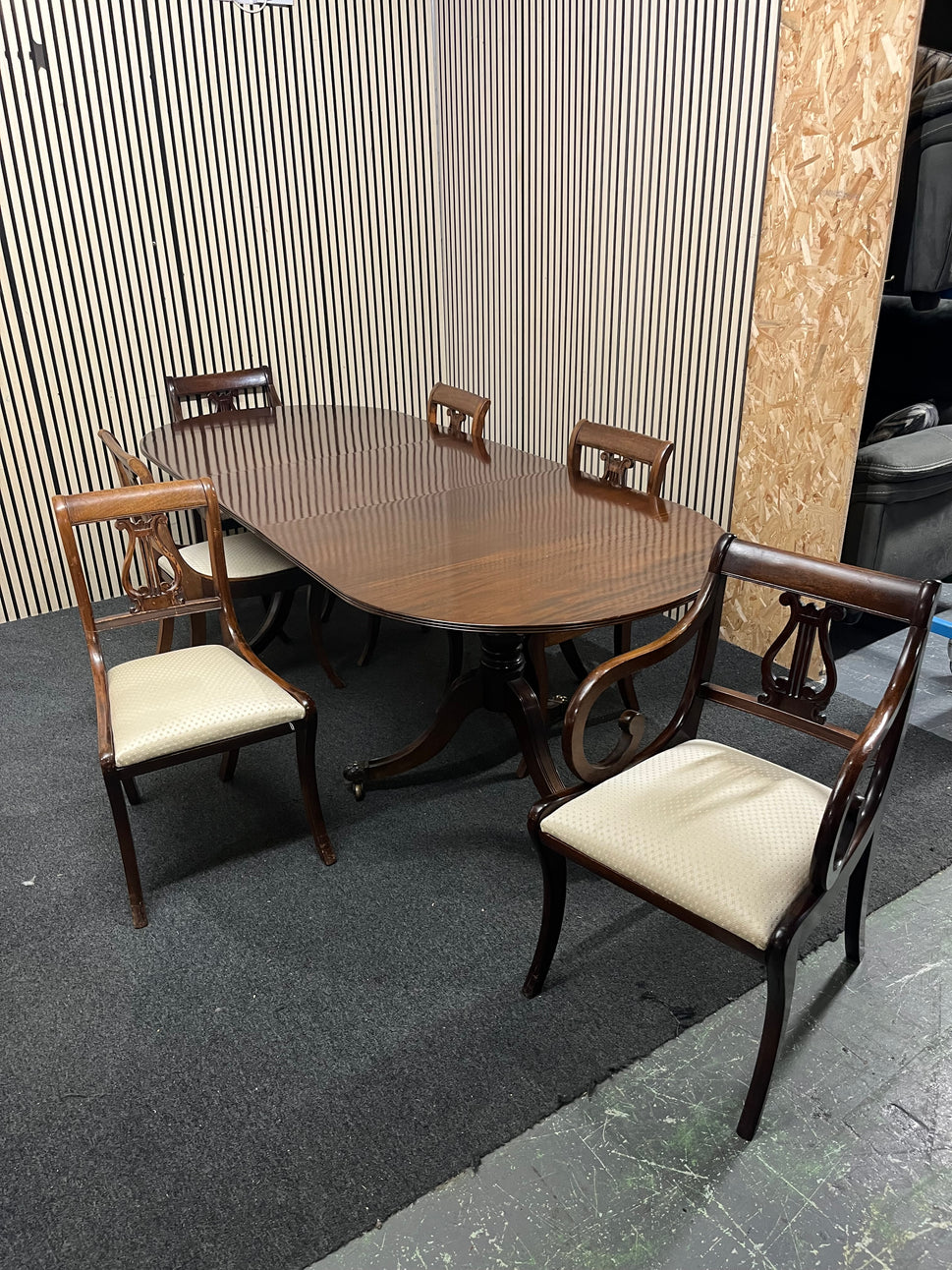 Mahogany dining set including oval pedestal table and six chairs.  44369