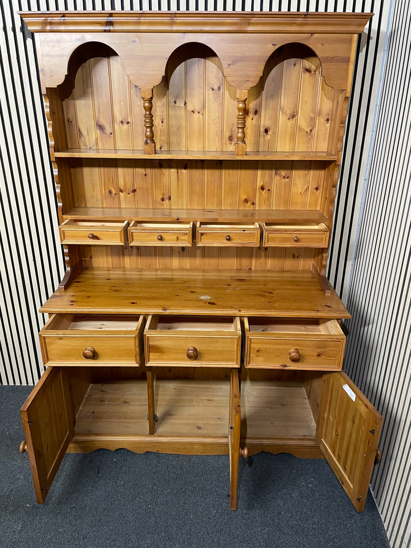 Traditional solid pine dresser with plate racks, drawers, and cupboards.  44495