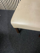 Pair of cream faux leather dining chair with dark wood legs.  44698