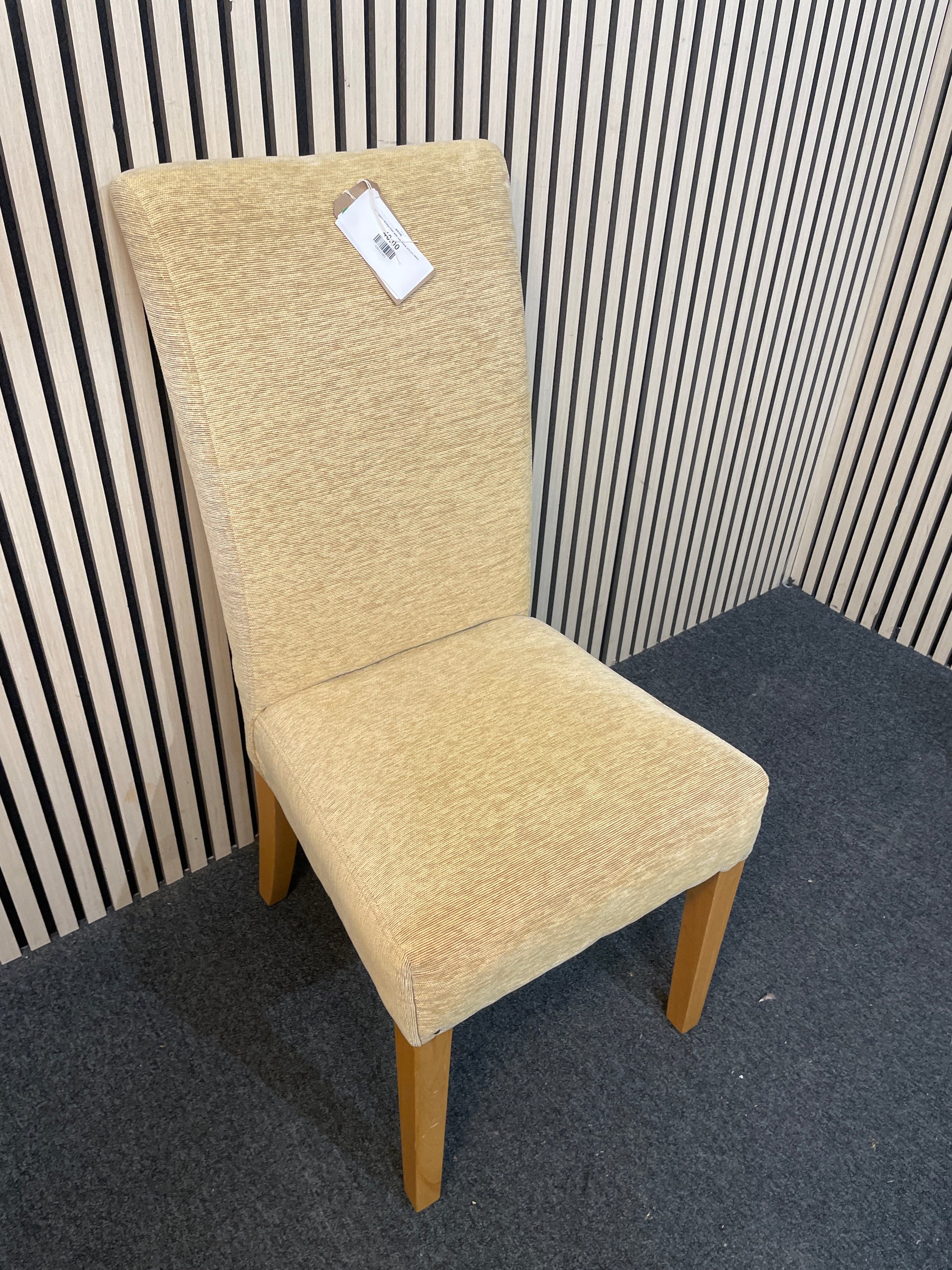 Gold fabric dining chair with oak frame and pin detail