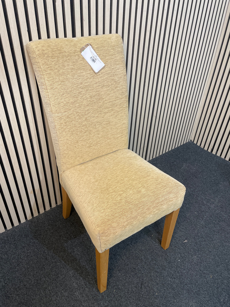Gold fabric dining chair with oak frame and pin detail
