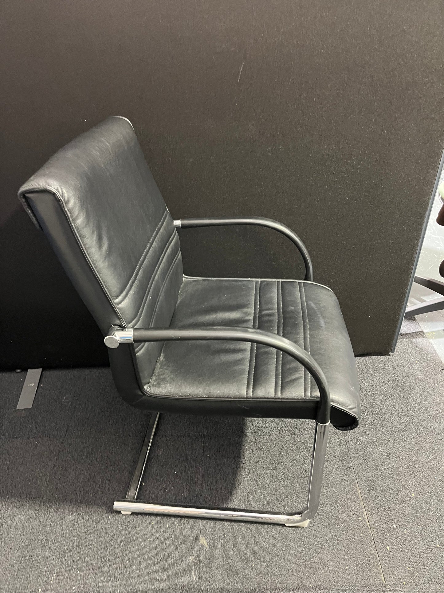 Black leather cantilever meeting chair with chrome frame