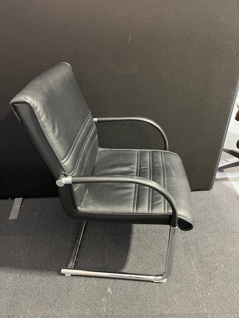 Black leather cantilever meeting chair with chrome frame