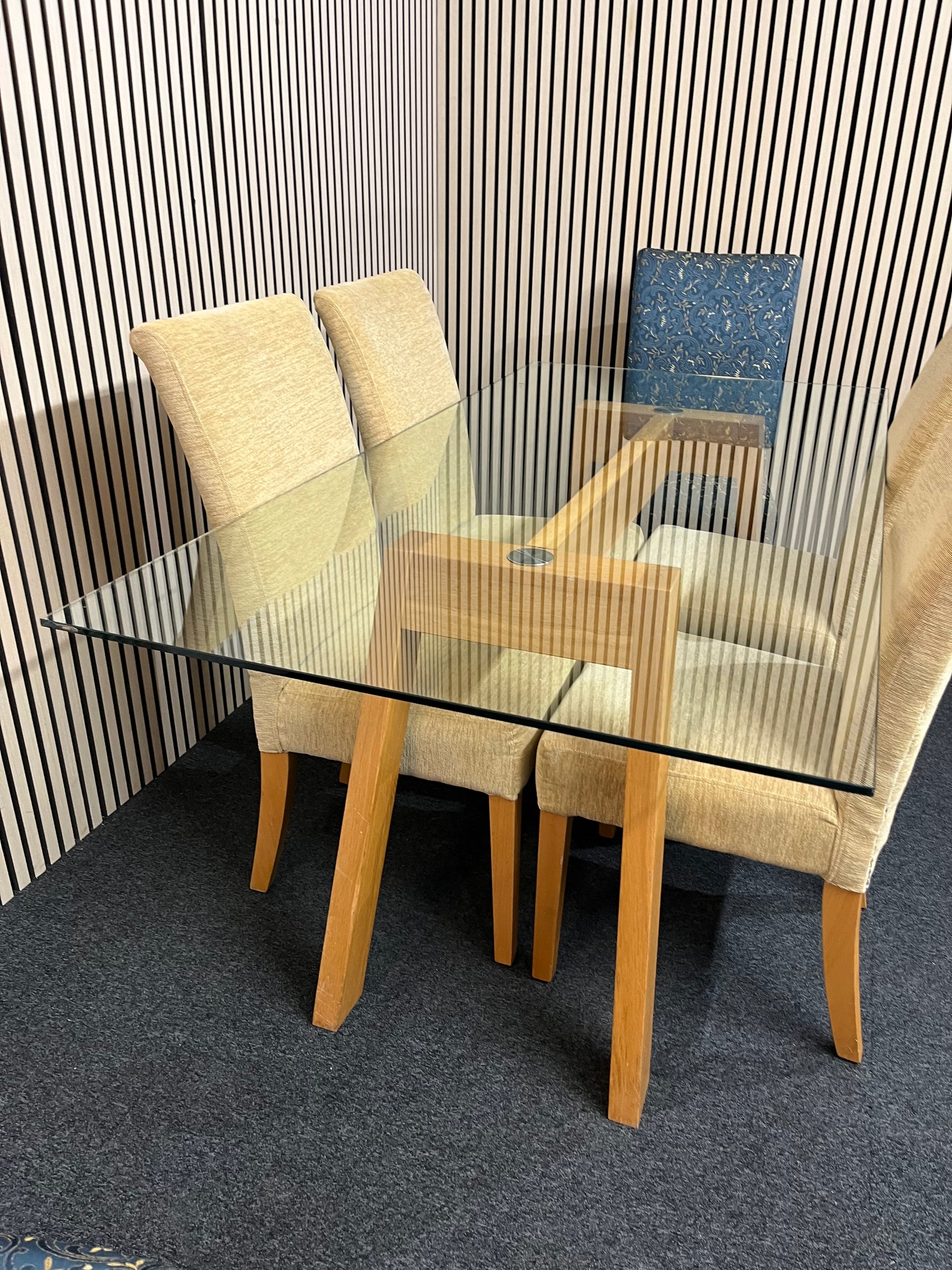 Long glass rectangular dining table(W 180 x D 90 cm) with 4 no. high back brown fabric dining chairs and 2 no. navy and gold fabric end chairs