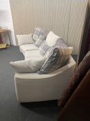 Large curved three-seater fabric sofa with matching scatter cushions.  44592