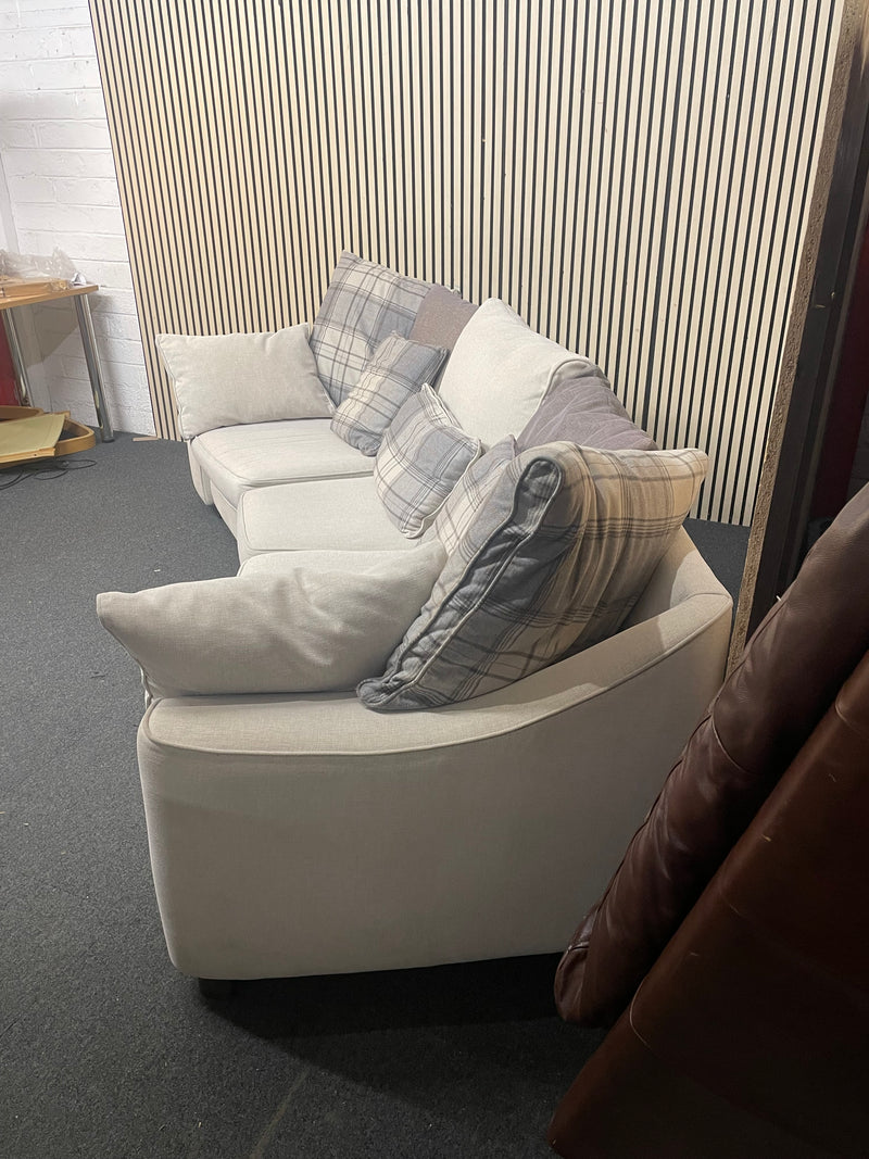 Large curved three-seater fabric sofa with matching scatter cushions.  44592