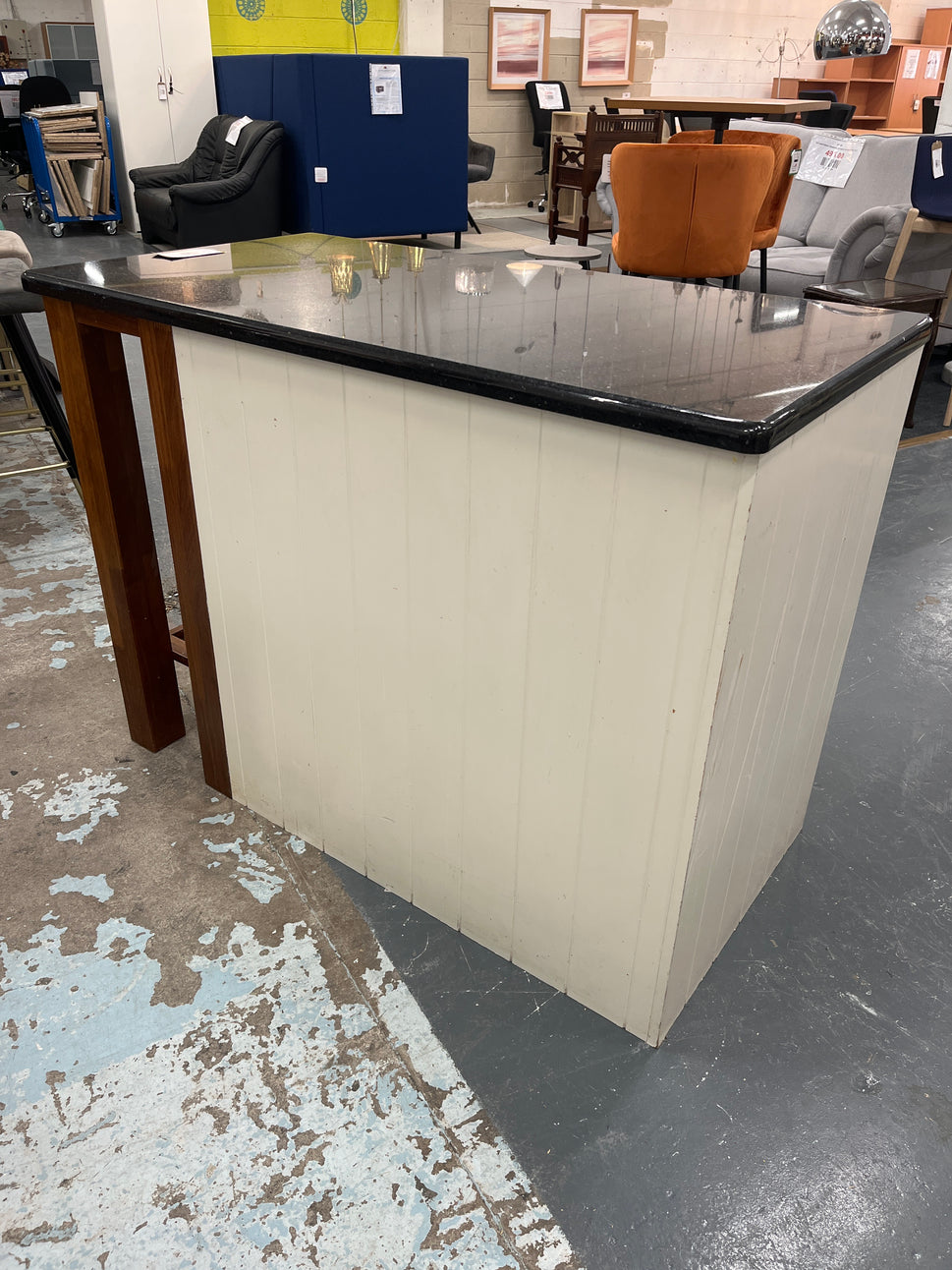 Granite kitchen island with cream frame and dark wood shelf unit  2125