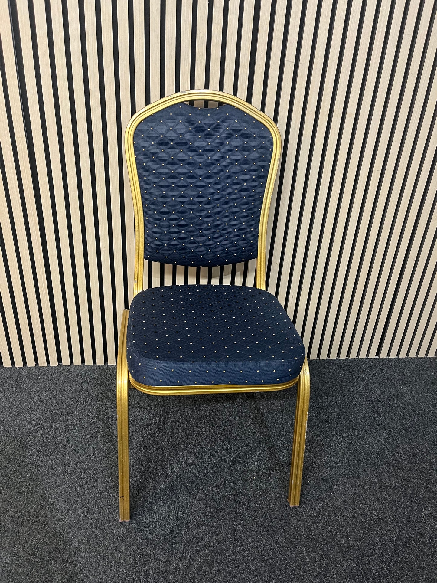 Blue patterned fabric banquet stacking chair with gold effect metal frame
