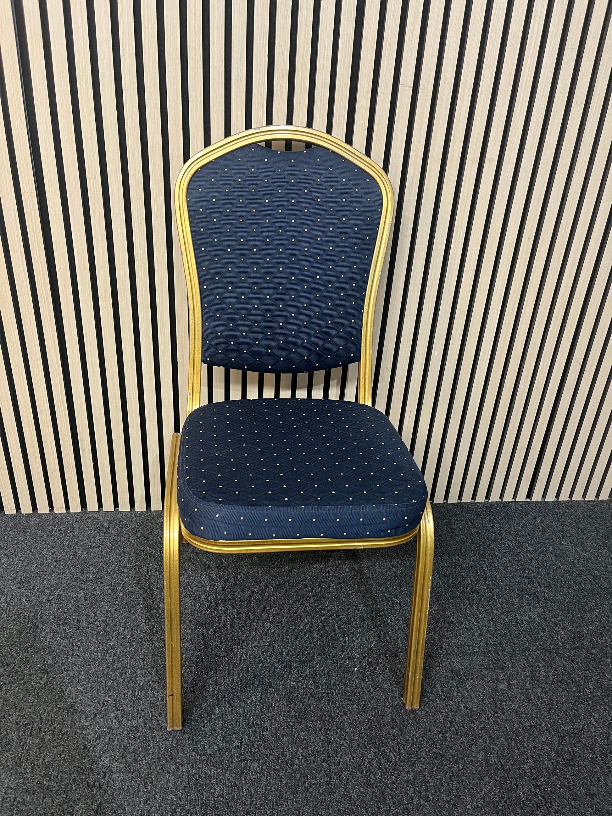 Blue patterned fabric banquet stacking chair with gold effect metal frame
