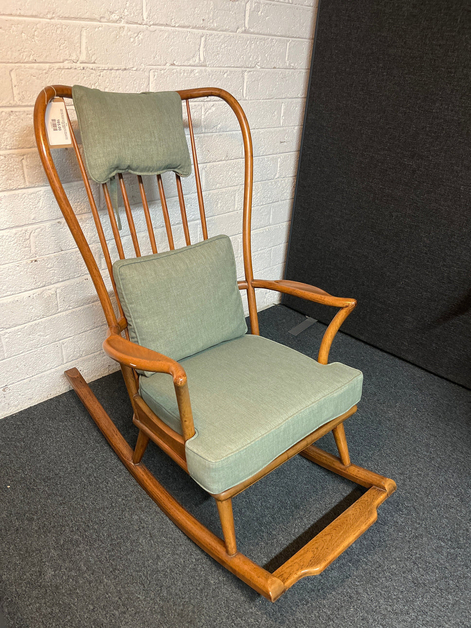 Solid oak high back ornate rocking chairs with sea green fabric seat cushion and back. Missing one spindle on the back  2225