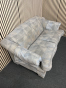 Two seater sofa with blue polka dot pattern and cushions.  44519