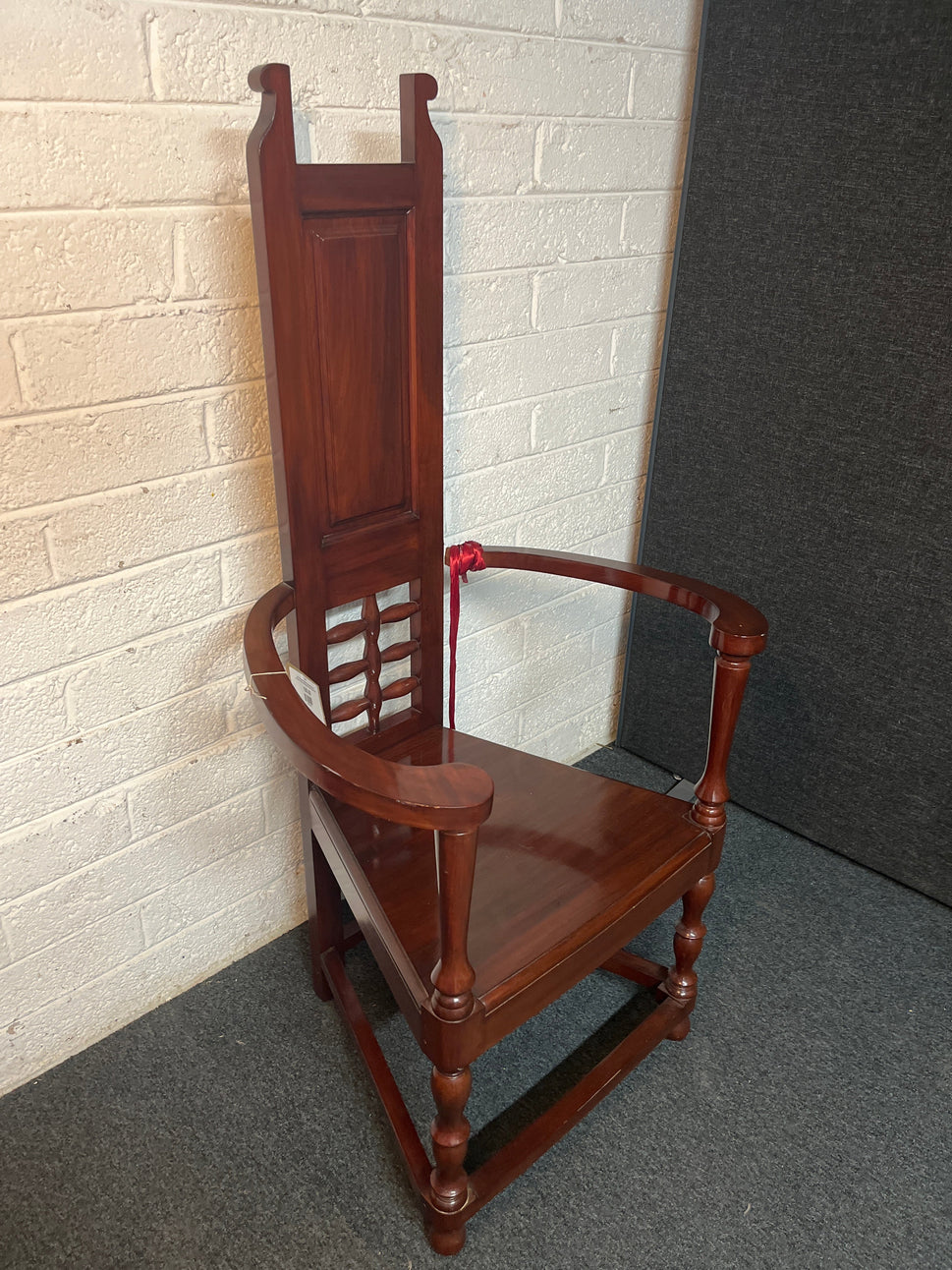 Solid teak polished stained occasional high back armchair. One arm with damage to side but repaired 2225