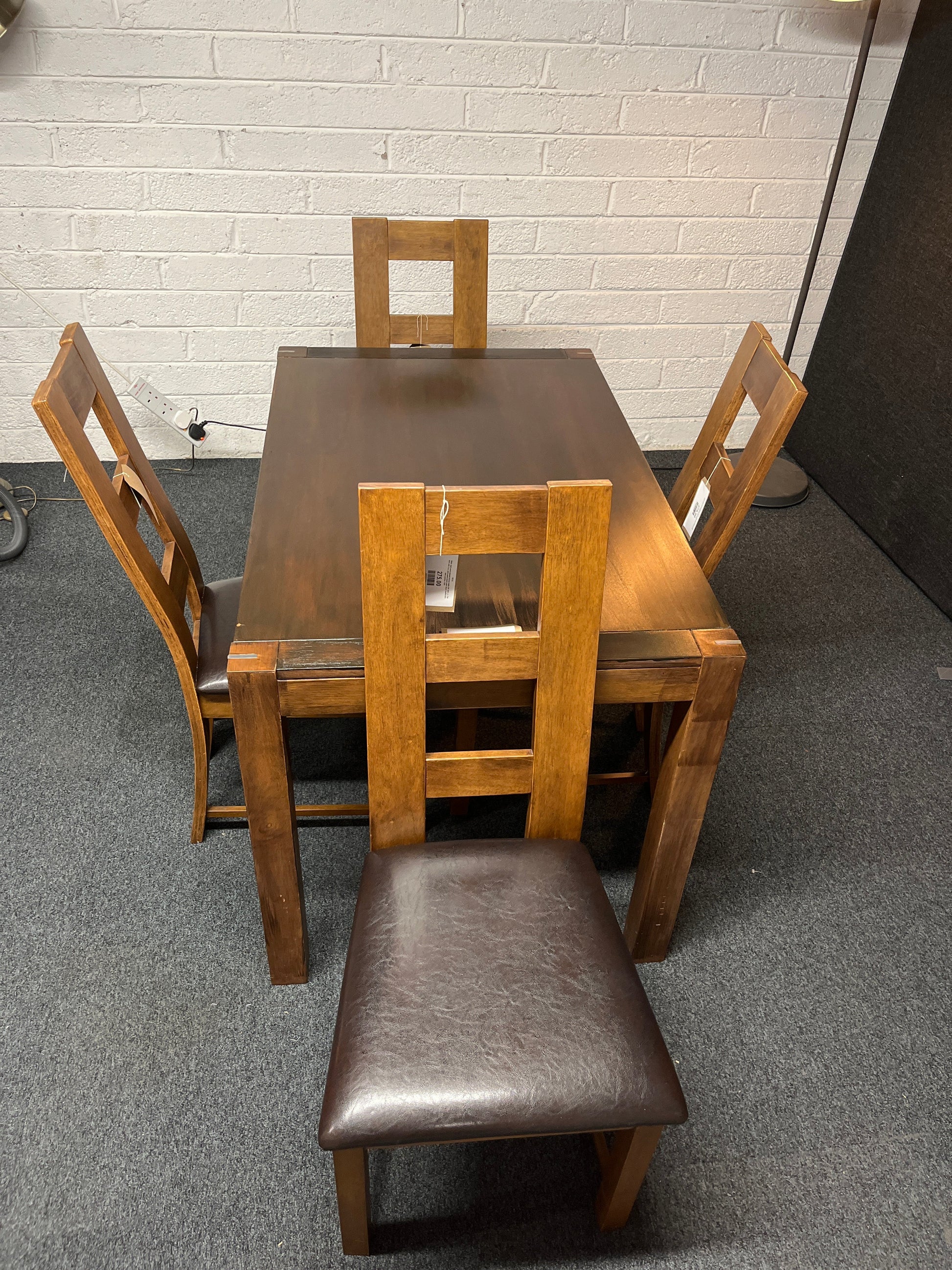Solid  dark wood stained kitchen table (W 1200 x L 750 mm) with 4 no. solid wood chairs with black leatherette seat cushion 1225