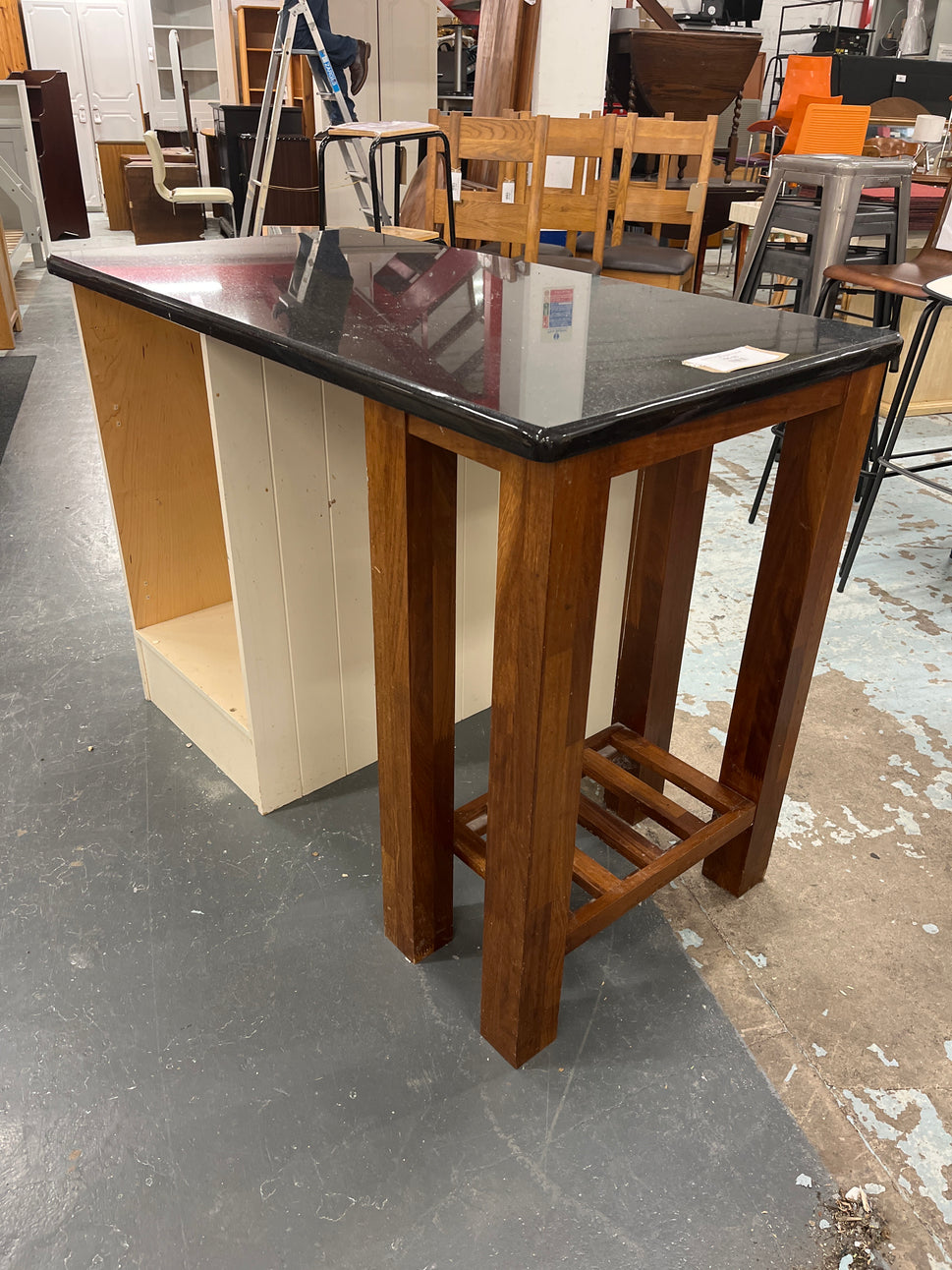 Granite kitchen island with cream frame and dark wood shelf unit  2125