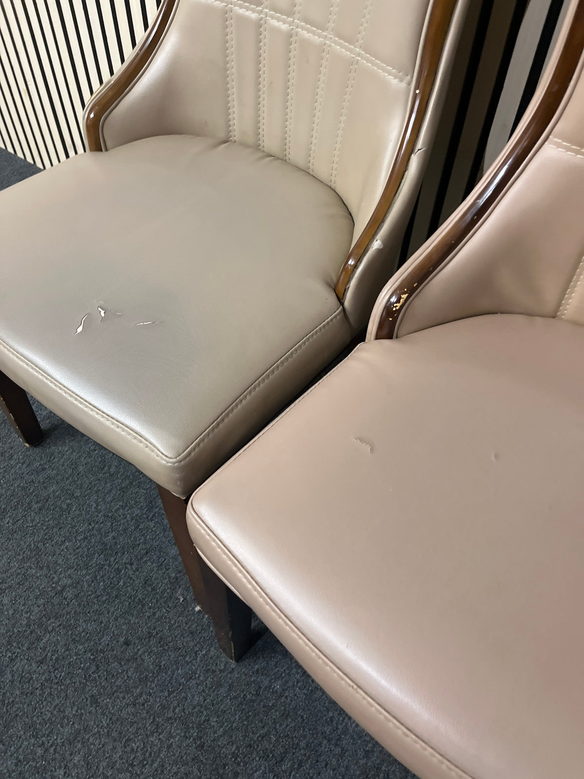 Two grey stitched faux leather dining chairs with wooden trim.  44373