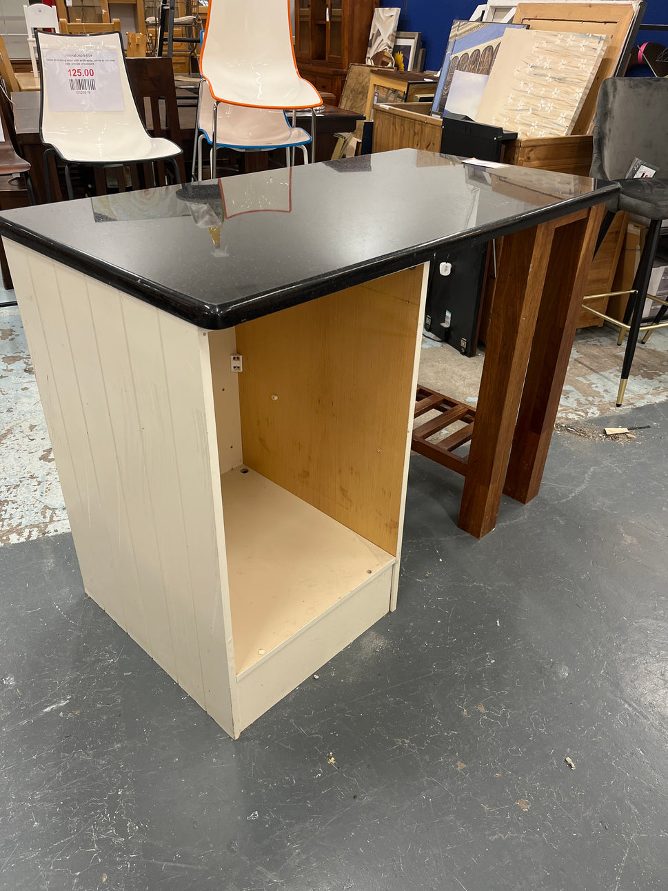 Granite kitchen island with cream frame and dark wood shelf unit  2125