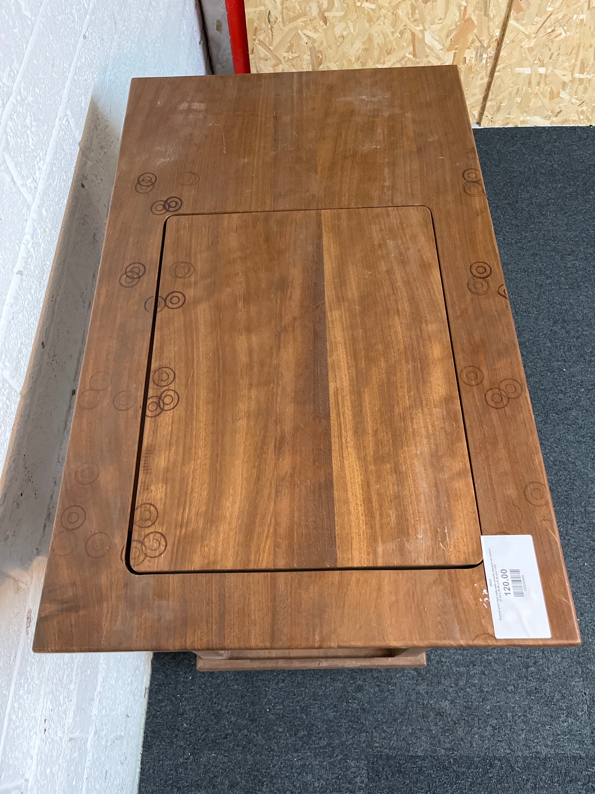 Stained pine high table with circular designs on castors (H 92 x W 90 x D 55 cm) 1325