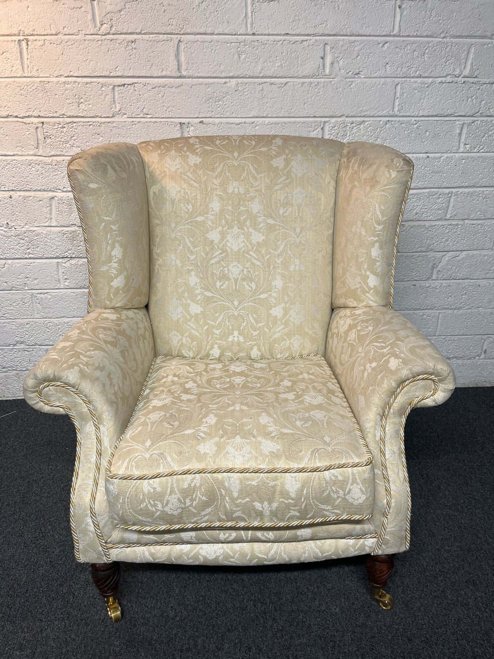 Cream mix fabric Queen Anne armchair solid wood frame, brass castors. 2225