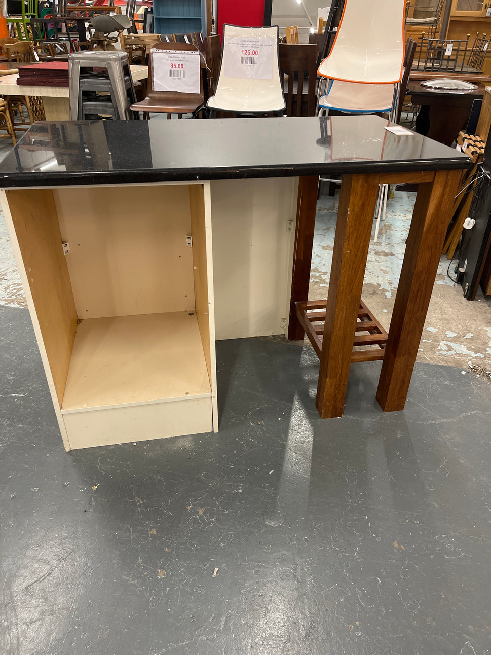 Granite kitchen island with cream frame and dark wood shelf unit  2125