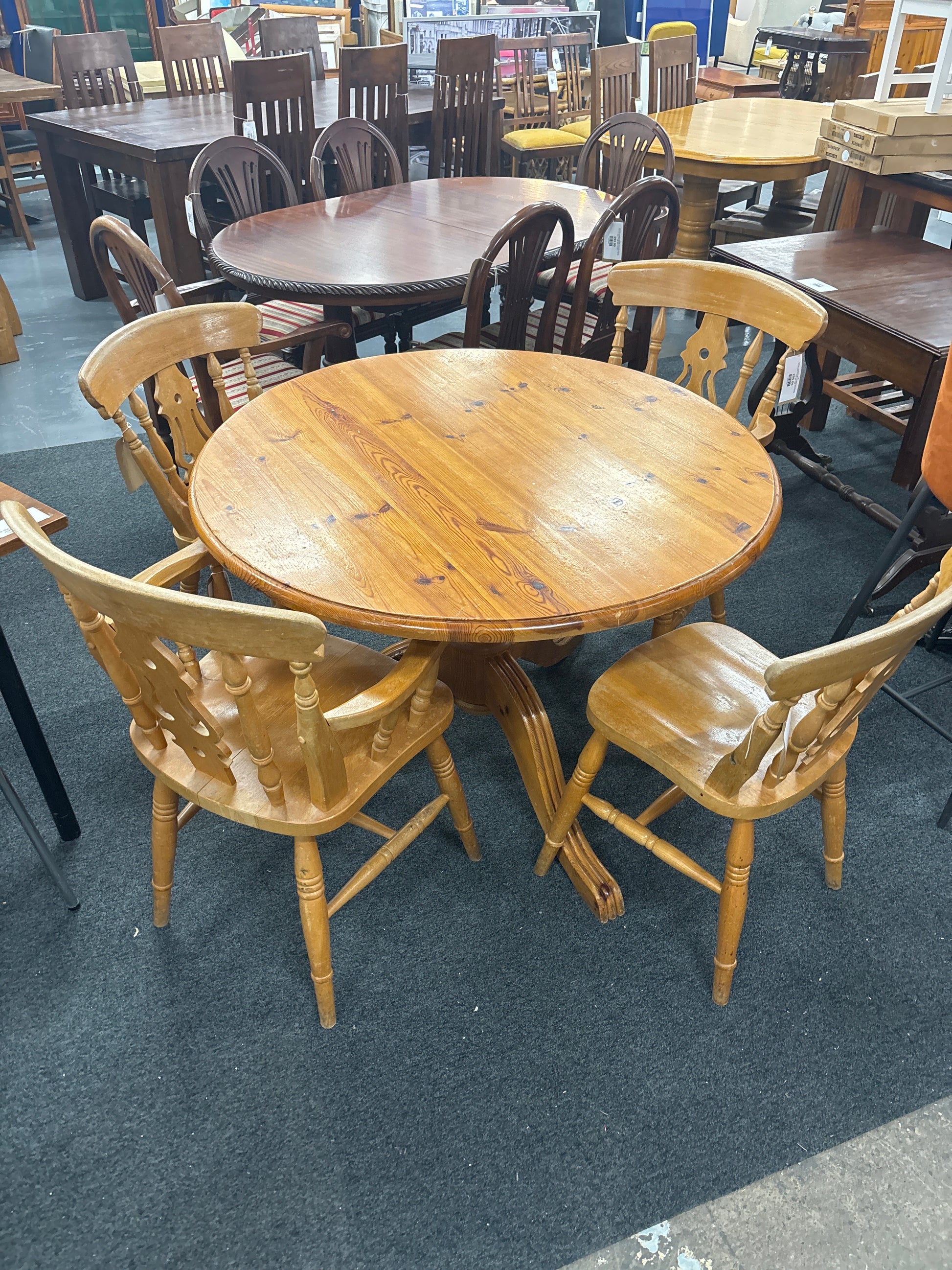 Solid pine circular kitchen table(1060 mm in diameter), central podium base with 3 no. dining chairs and 2 no. carver chairs  3125