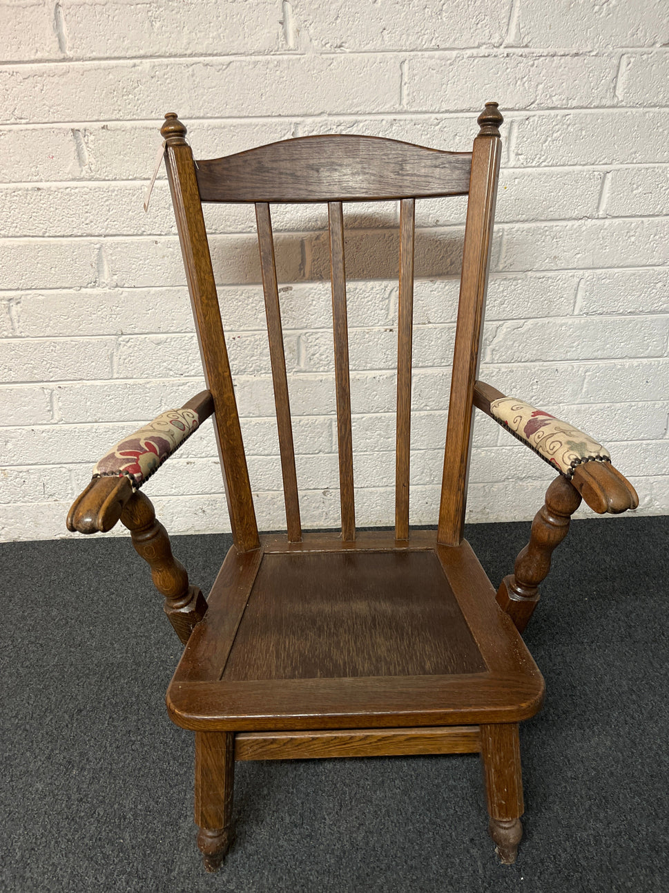 Dark wood stained armchair with padded fabric arms  2225