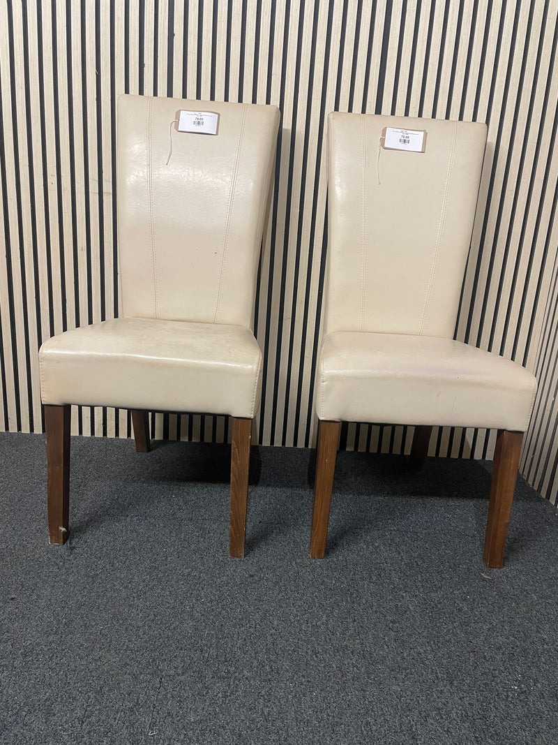 Pair of cream faux leather dining chair with dark wood legs.  44698