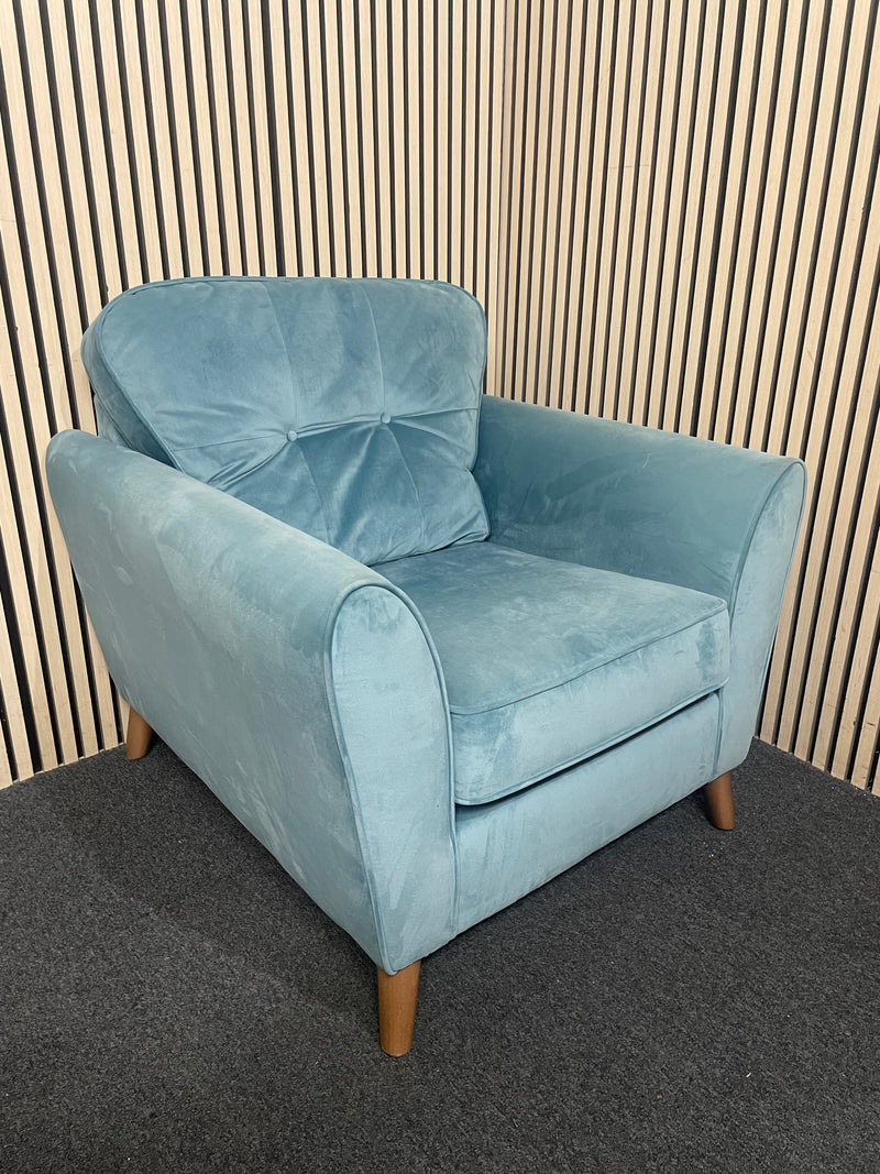 A modern duck egg blue velvet armchair with piped edges.  44696