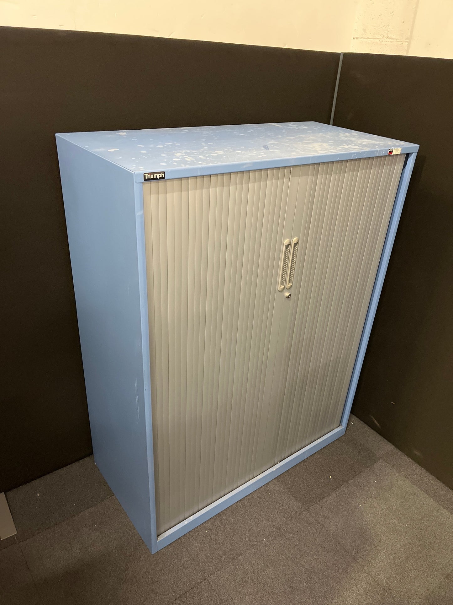 Secondhand Triumph Blue metal framed, silver plastic sliding door tambour  with 2 no. internal shelves and 1 no. key 1000Wx1290Hx475D