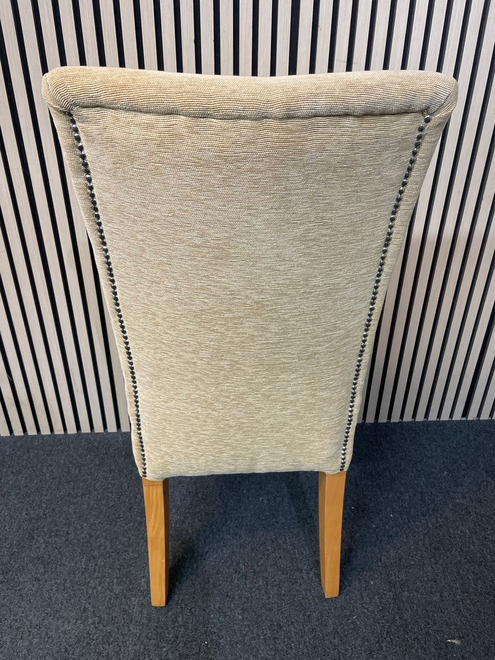 Gold fabric dining chair with oak frame and pin detail