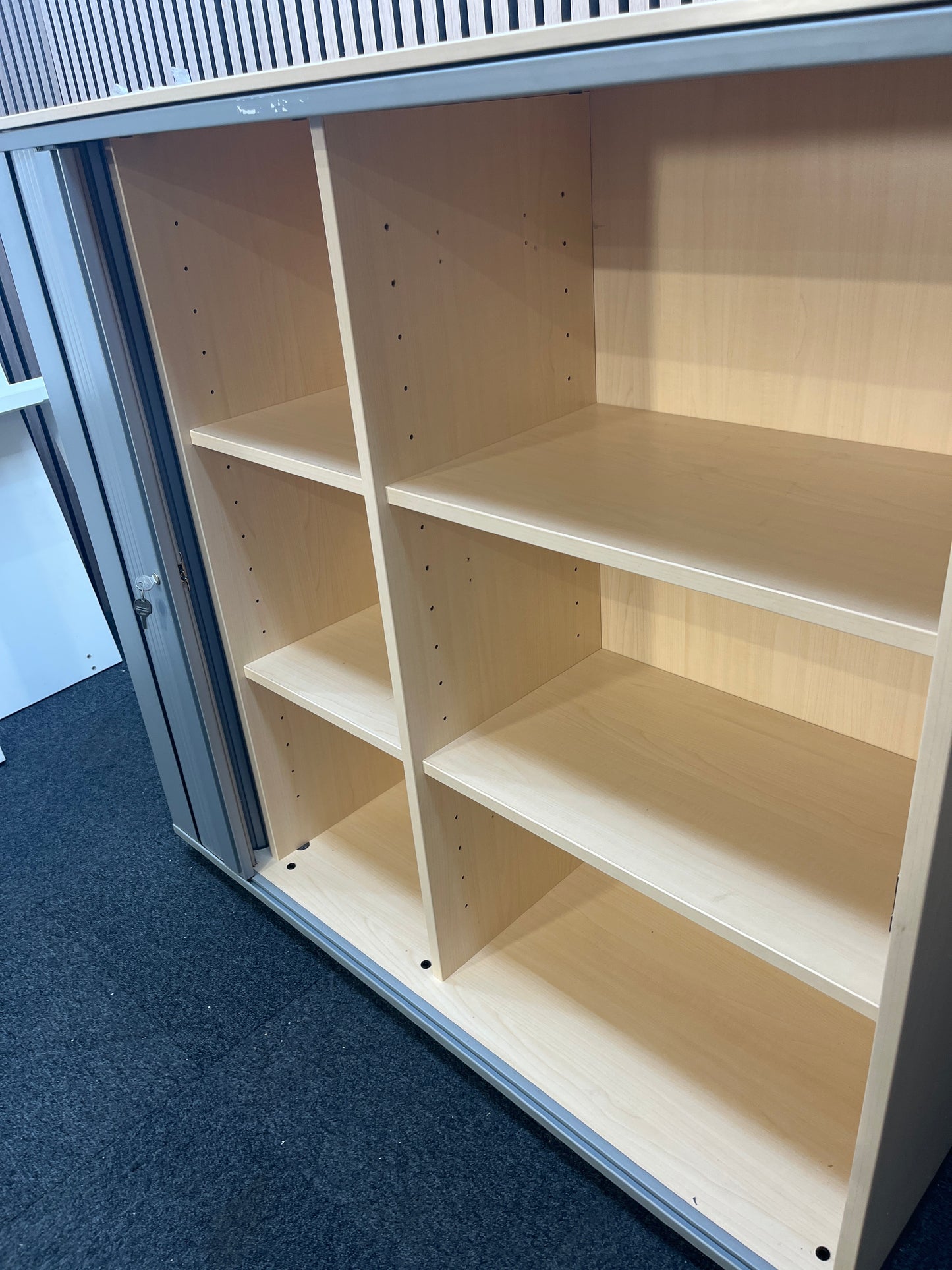 Maple laminate silver framed, side opening tambour with internal shelves (H 113 x W 120 x D 44 cm) J3847