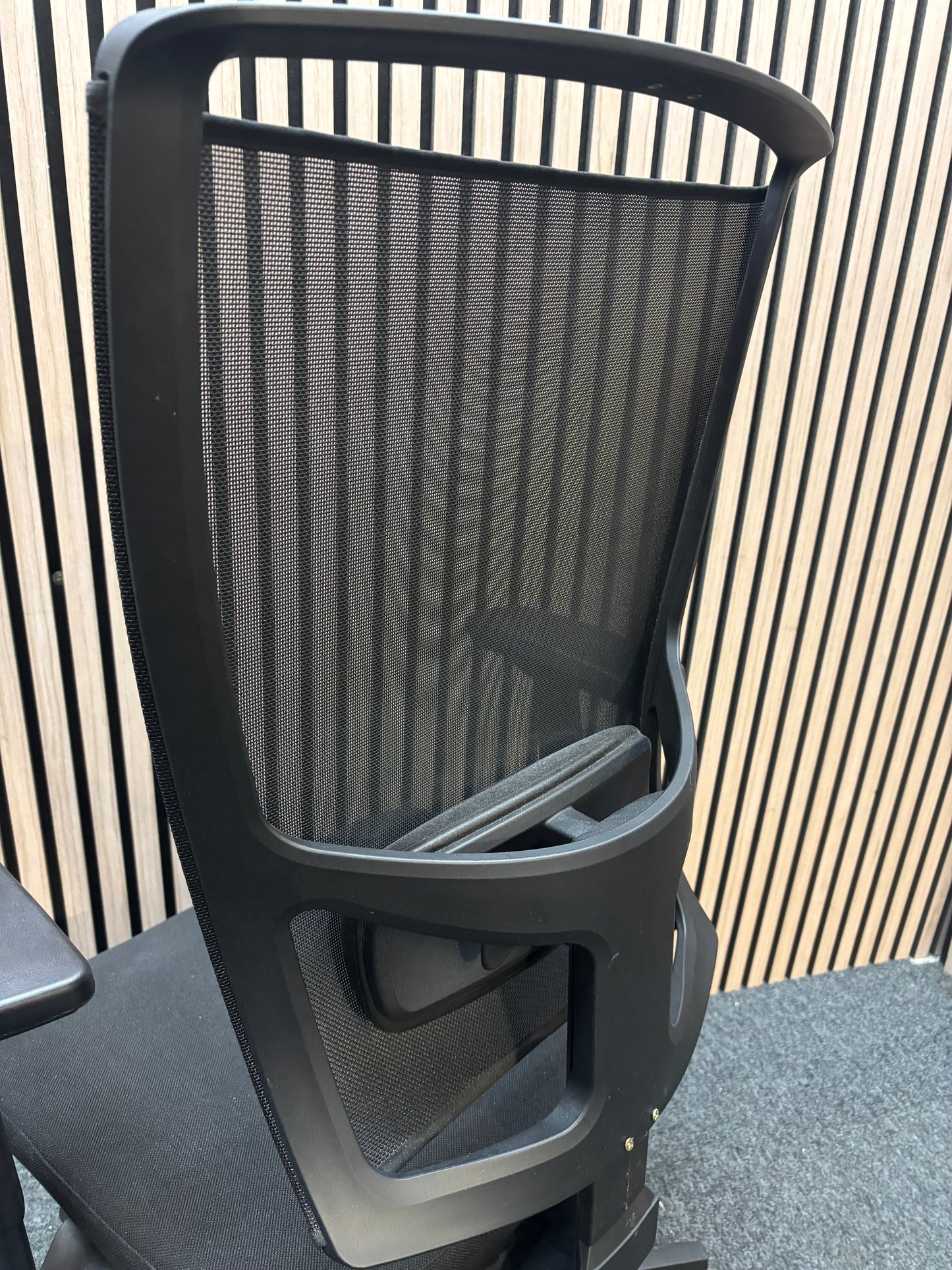 Black mesh back swivel chair with adjustable arms and 5 star swivel base