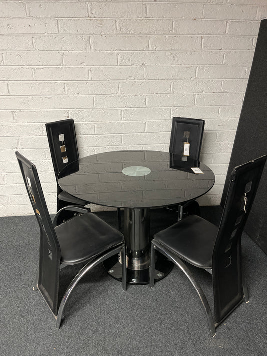 Black glass circular kitchen table (radius x 1060 mm), central base with 4 no. high back black leatherette and chrome dining chairs  1225