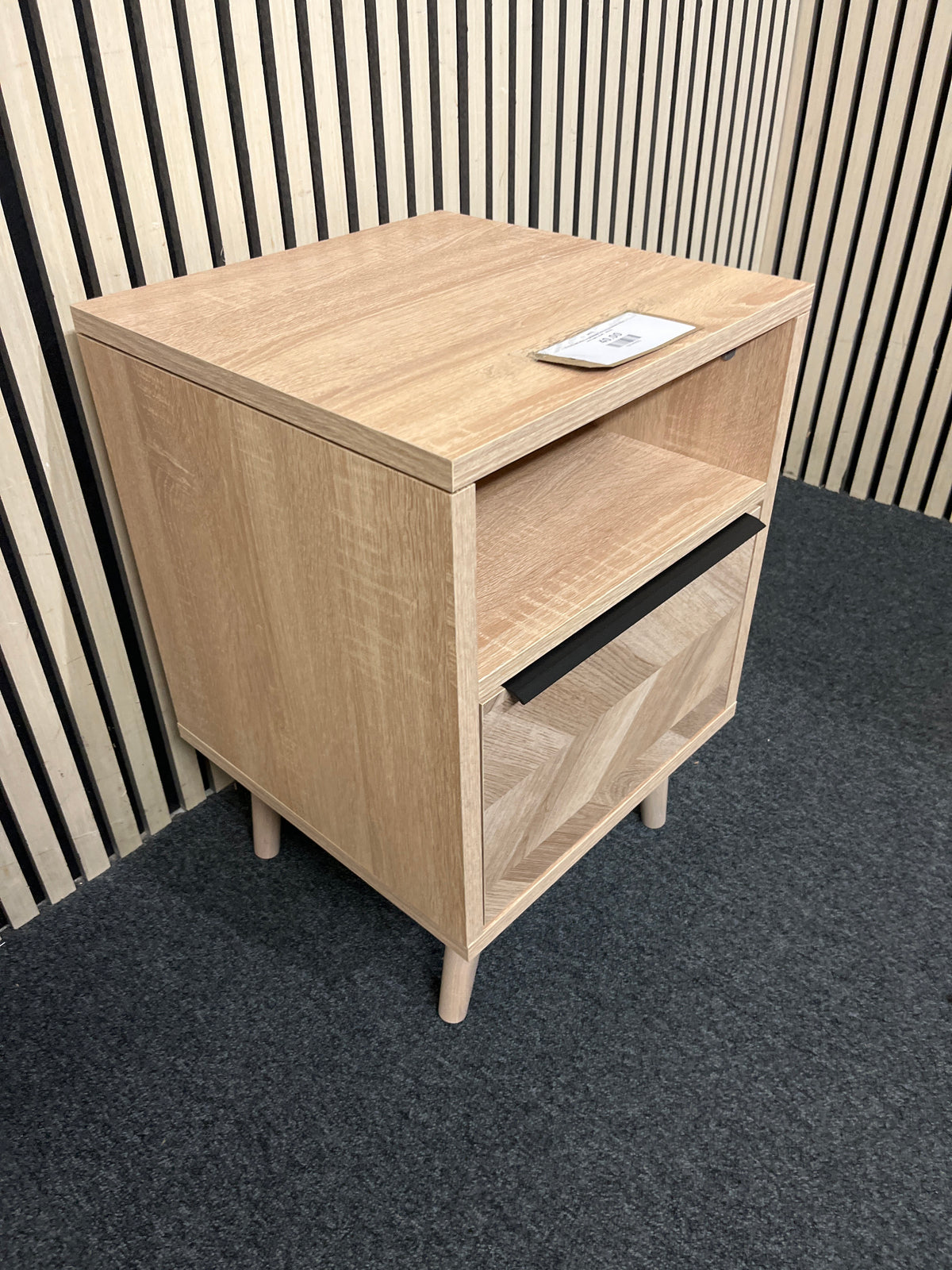 Modern oak effect nightstand featuring chevron detail and open shelf.  44374