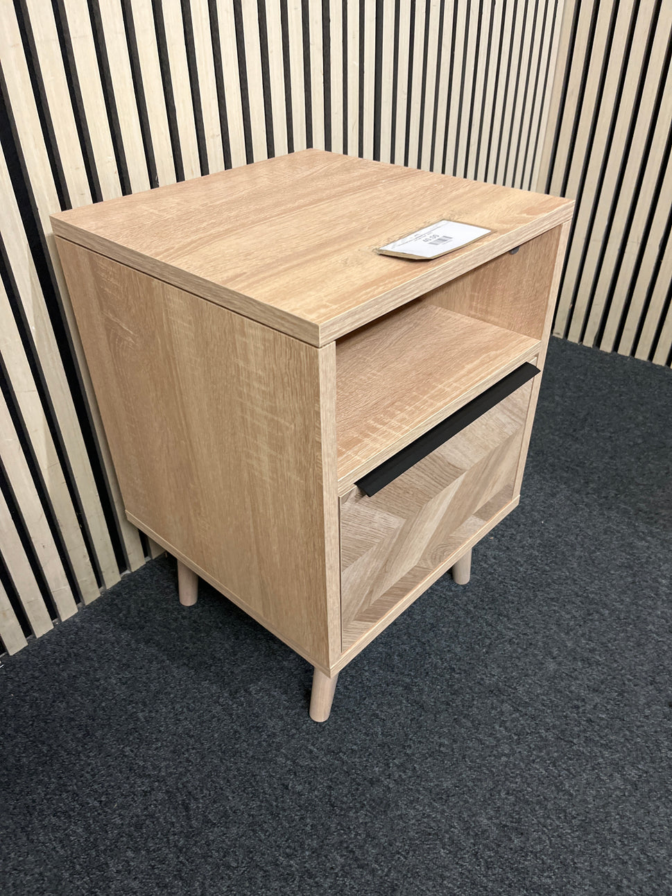 Modern oak effect nightstand featuring chevron detail and open shelf.  44374