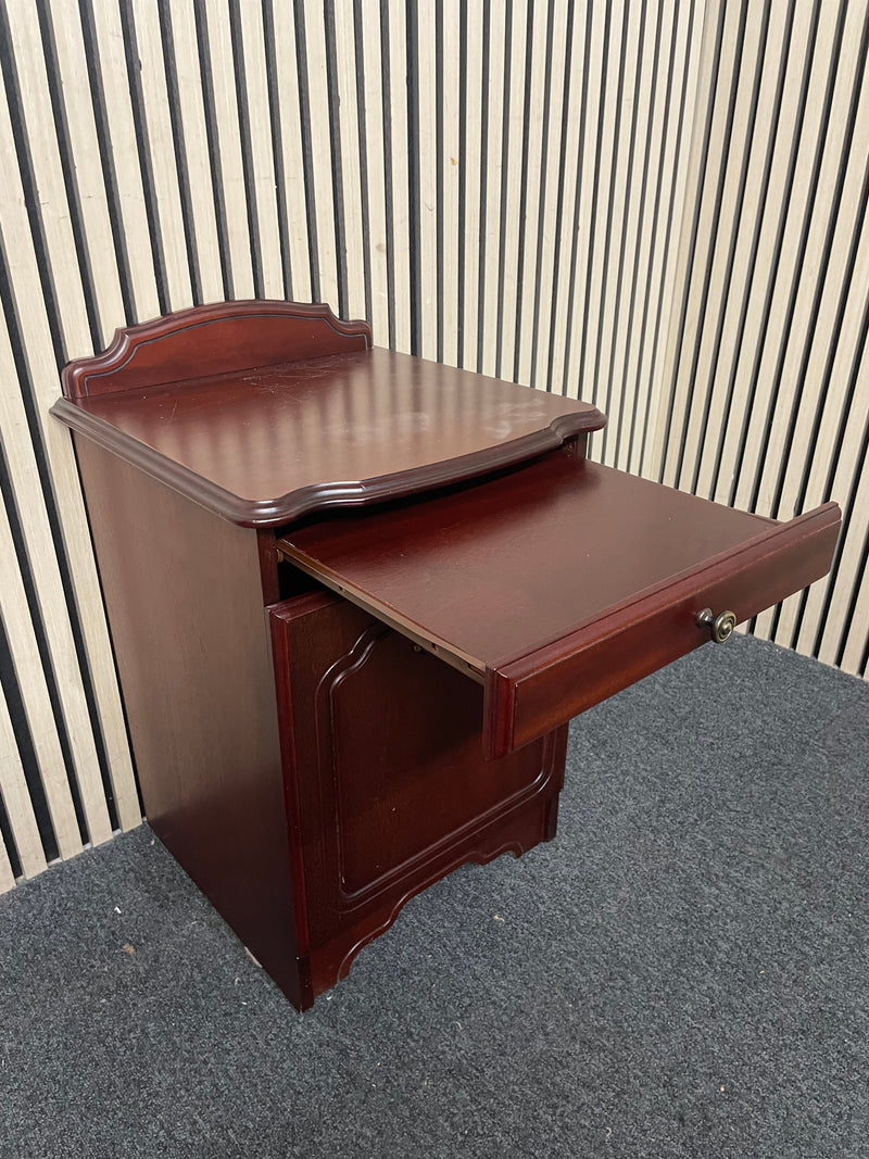Traditional dark wood nightstand with decorative edges and single drawer.  44667