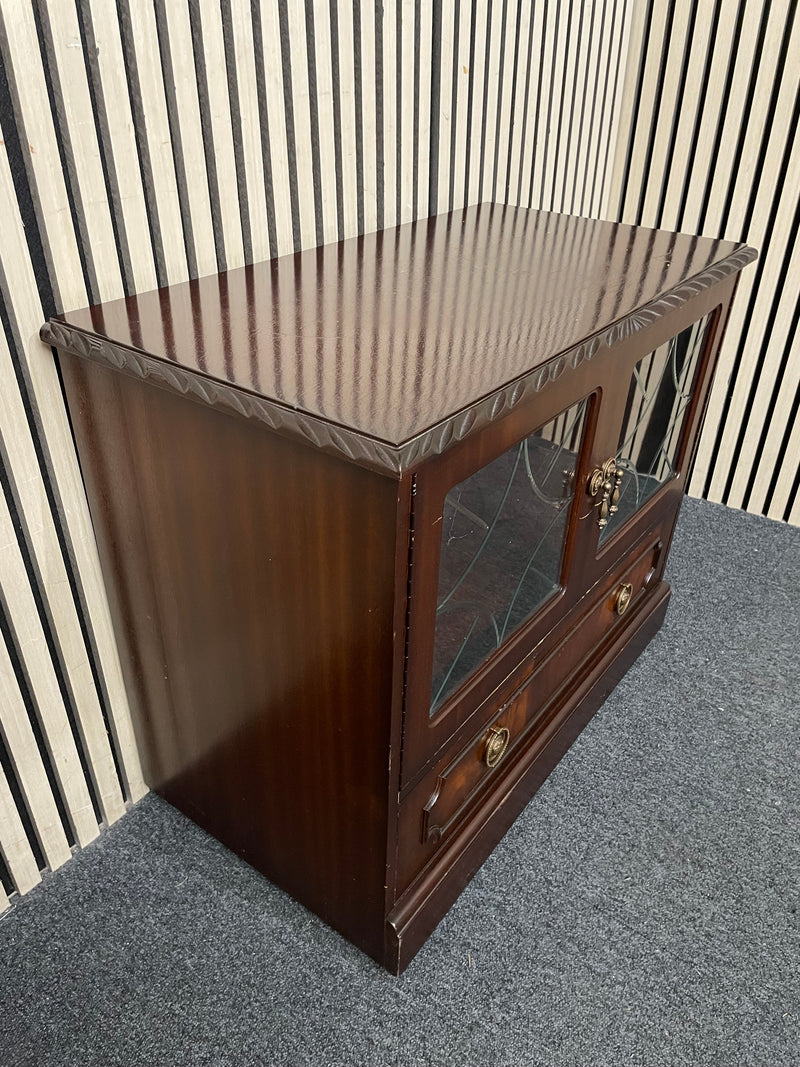 Dark wood TV unit with leaded glass doors and drawers.  44509