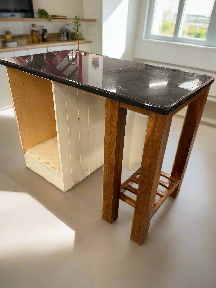 Granite kitchen island with cream frame and dark wood shelf unit  2125