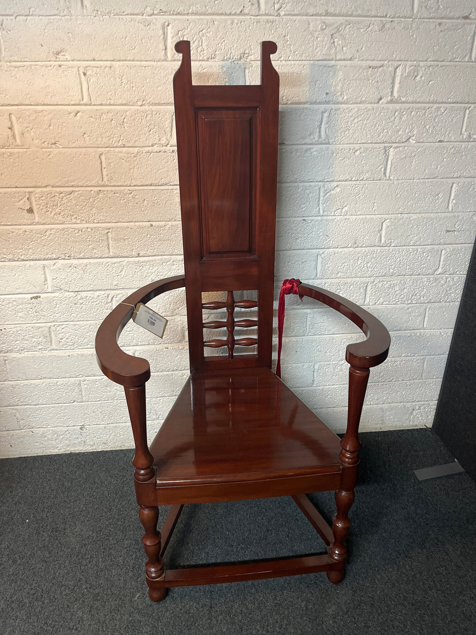Solid teak polished stained occasional high back armchair. One arm with damage to side but repaired 2225
