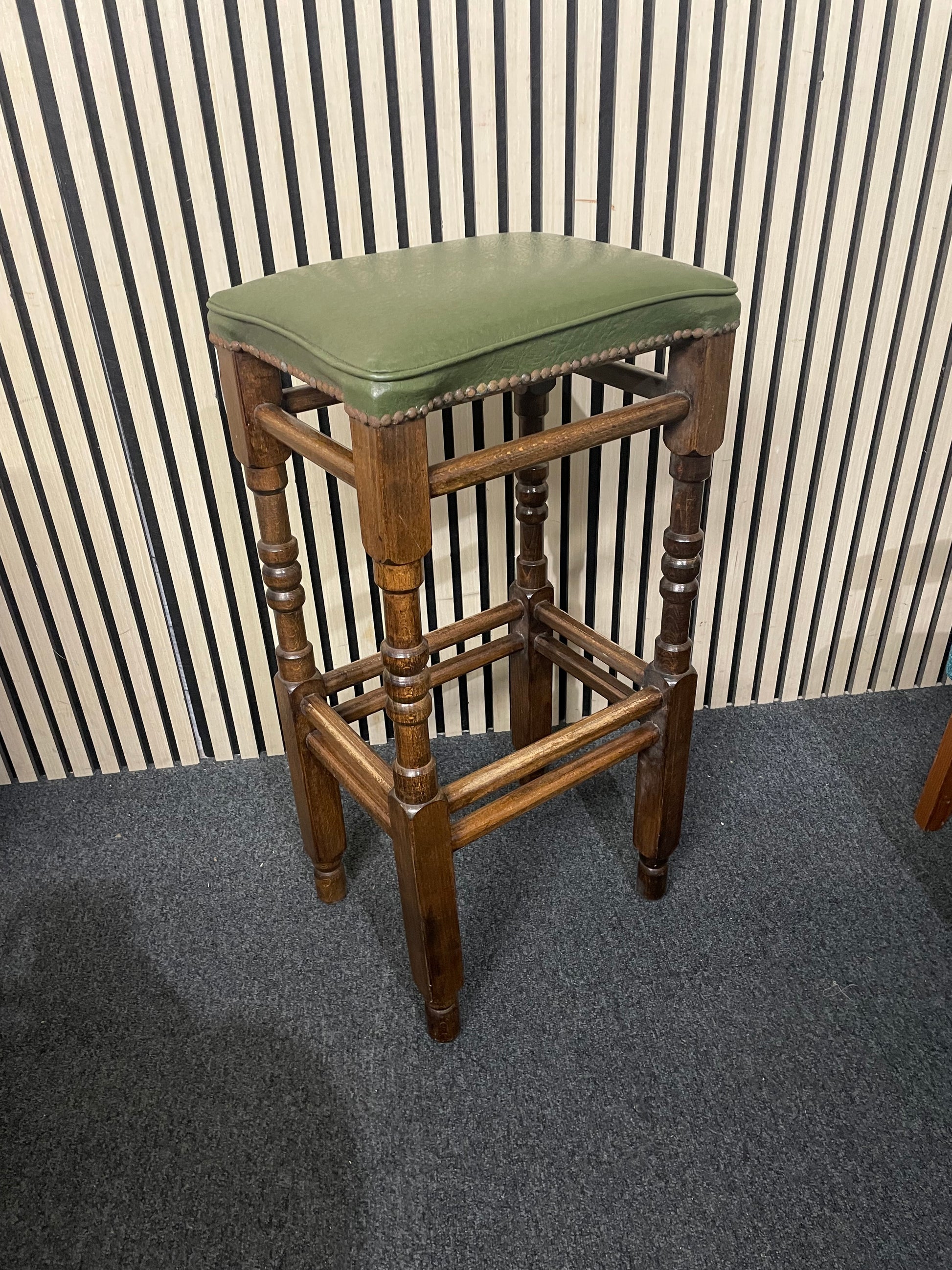 Ornate solid wooden framed high bar stool with green leatherette seat and button design 1126