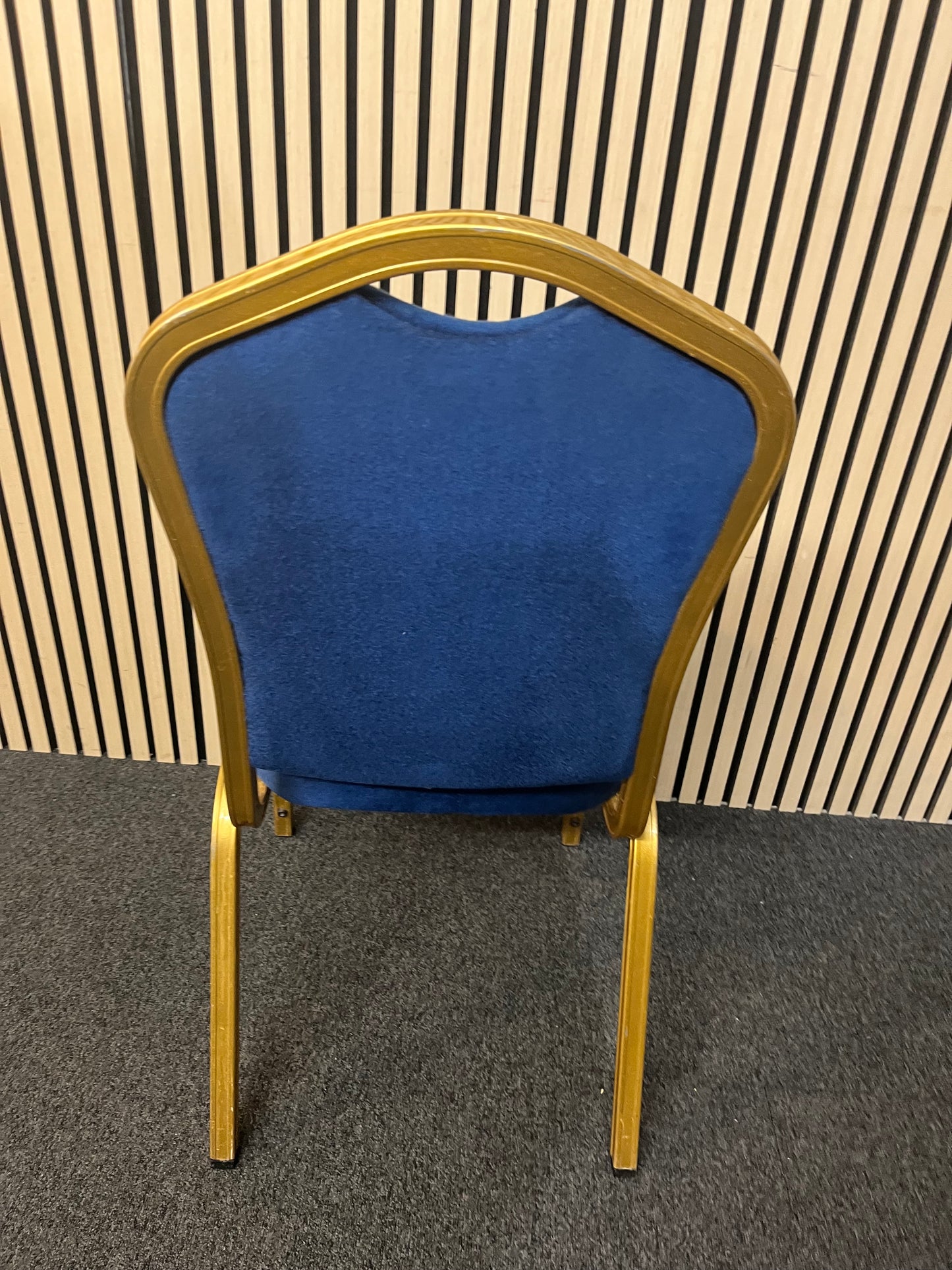 Blue fabric metal framed gold effect stacking banquet chair with curved top